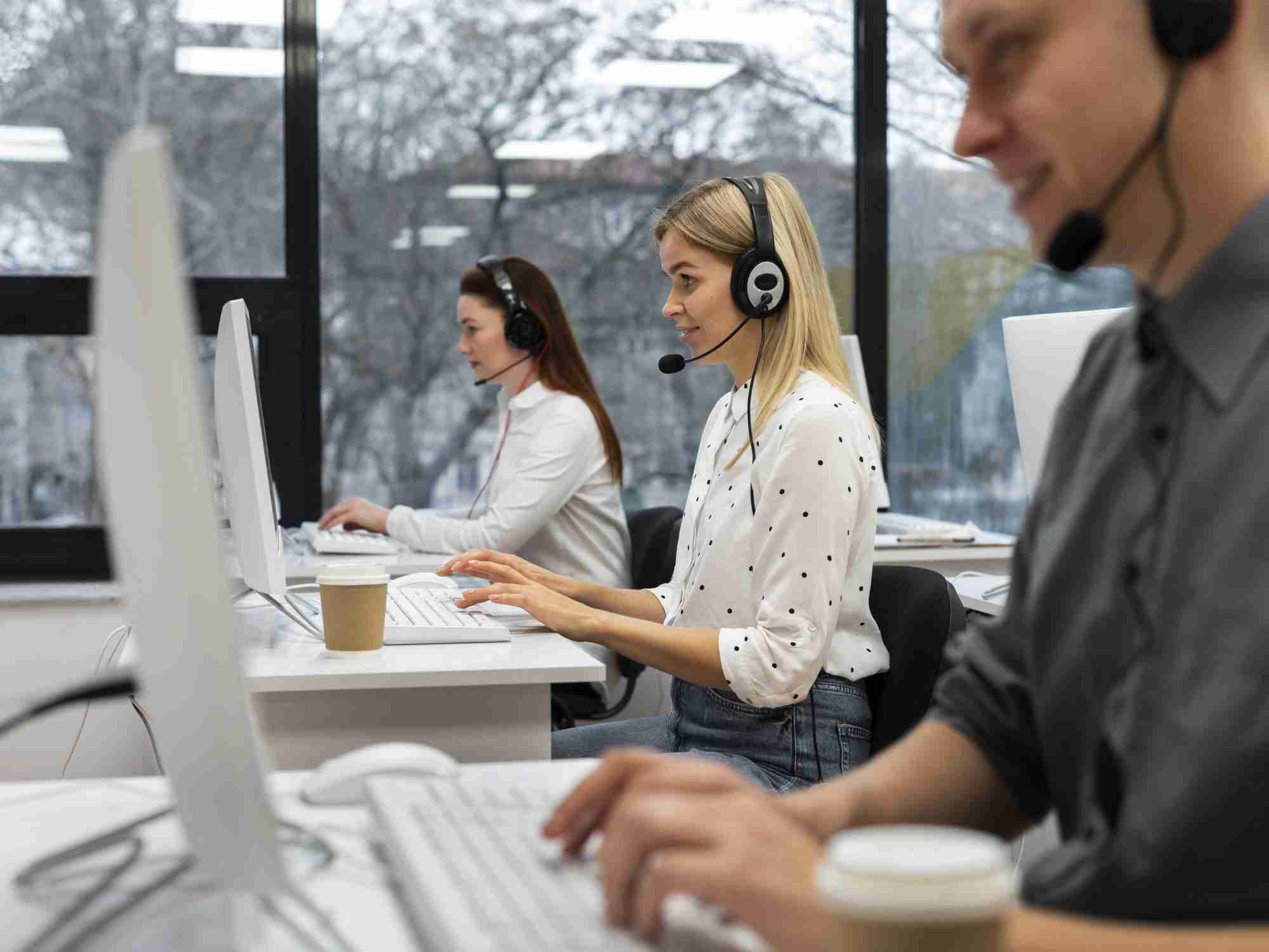 colleagues working together call center office with coffee edited scaled