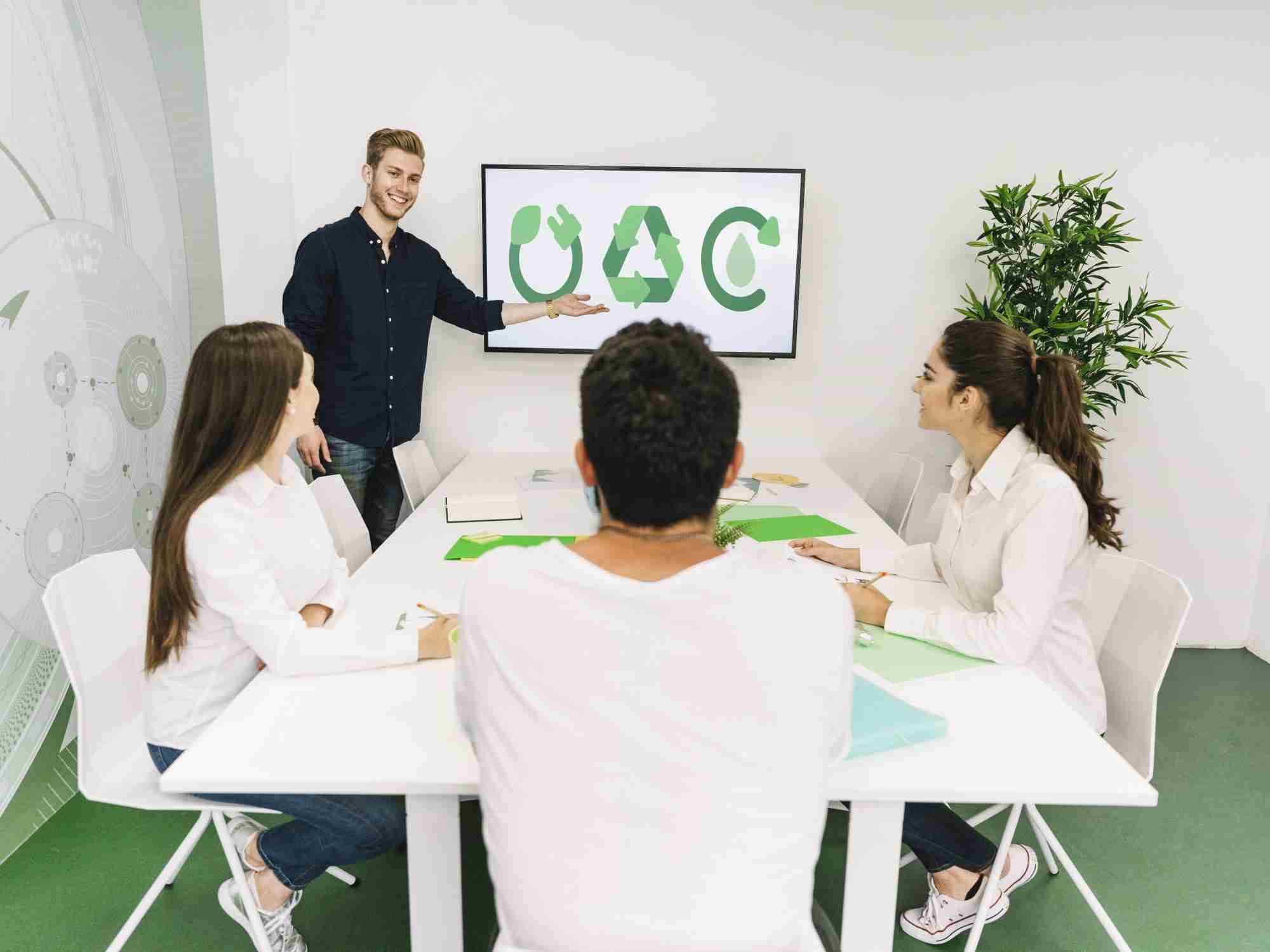 happy businesswoman giving presentation natural resources his colleagues 2 edited scaled