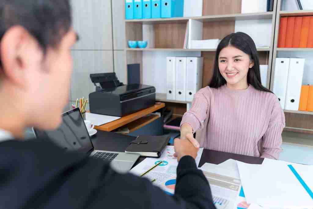 young working woman check hands with businessman