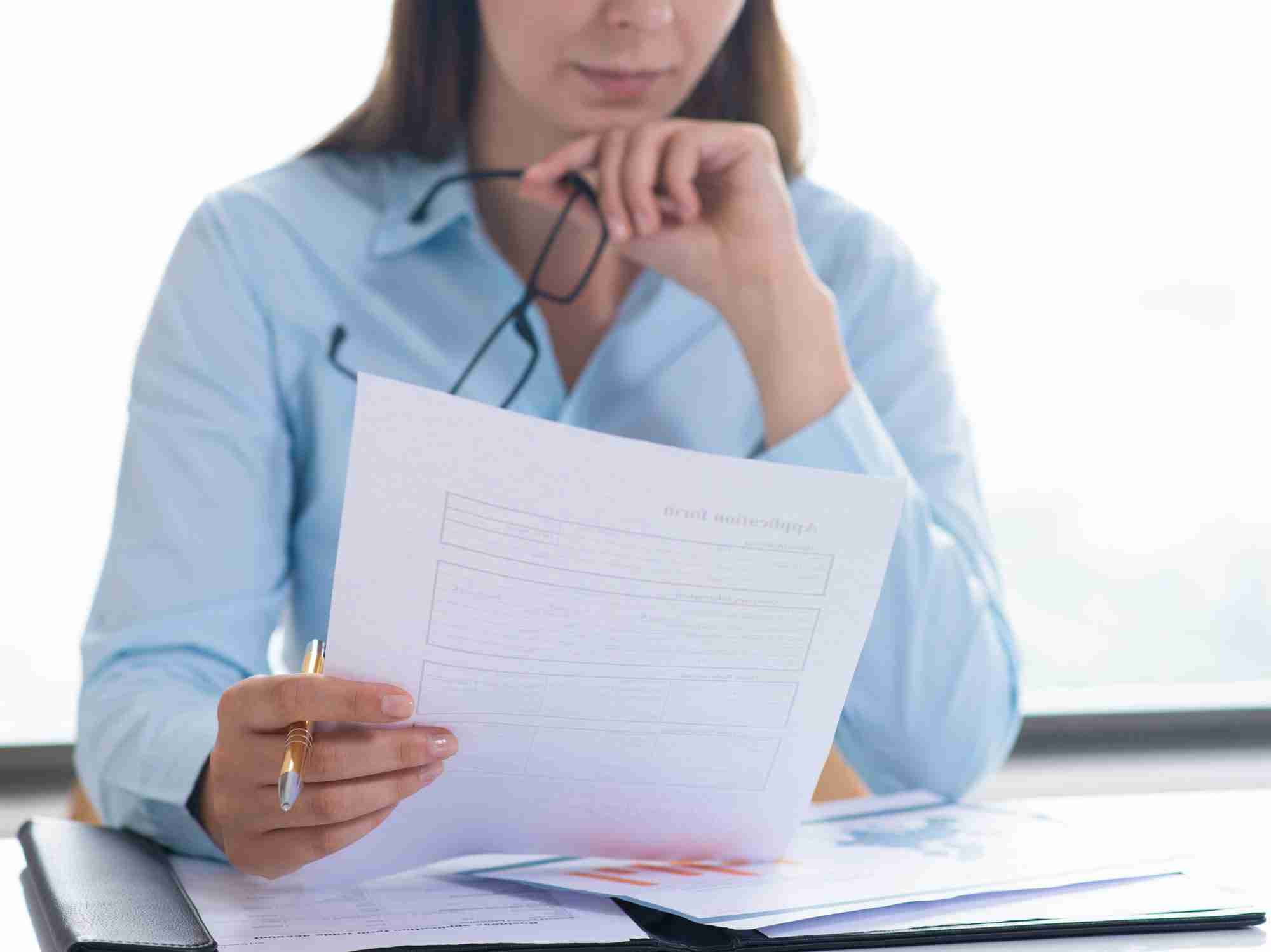 closeup woman holding reading document edited scaled