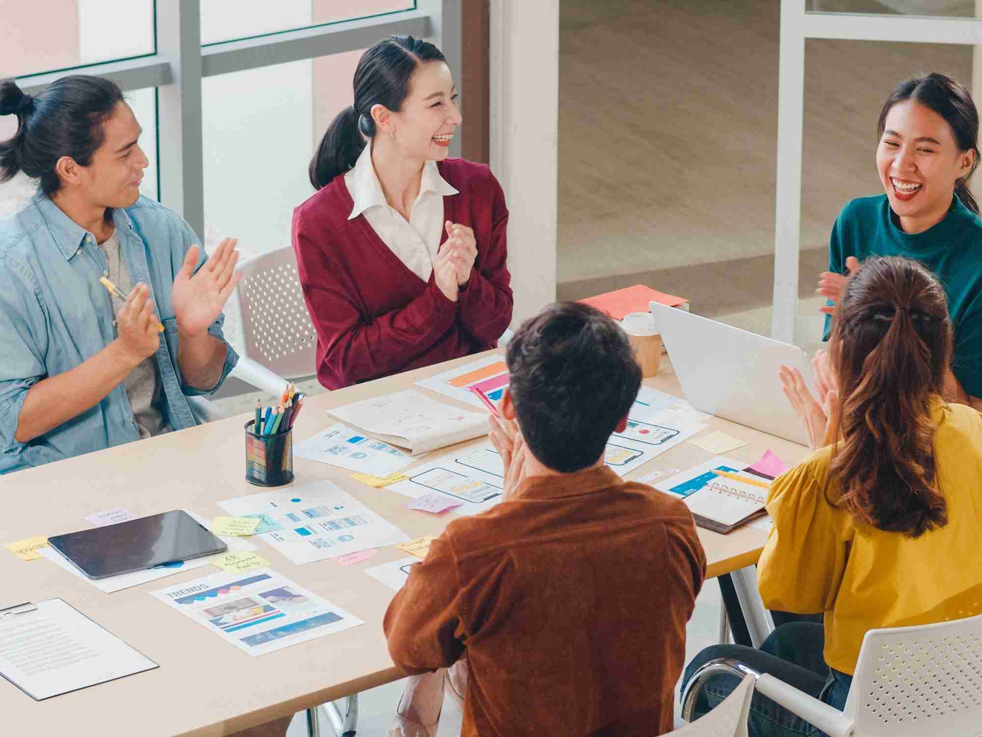 Incorporation vs employer of record (EOR) in China multiracial group asia young creative people smart casual wear discussing business clapping laughing smiling together brainstorm meeting office coworker teamwork successful concept edited scaled
