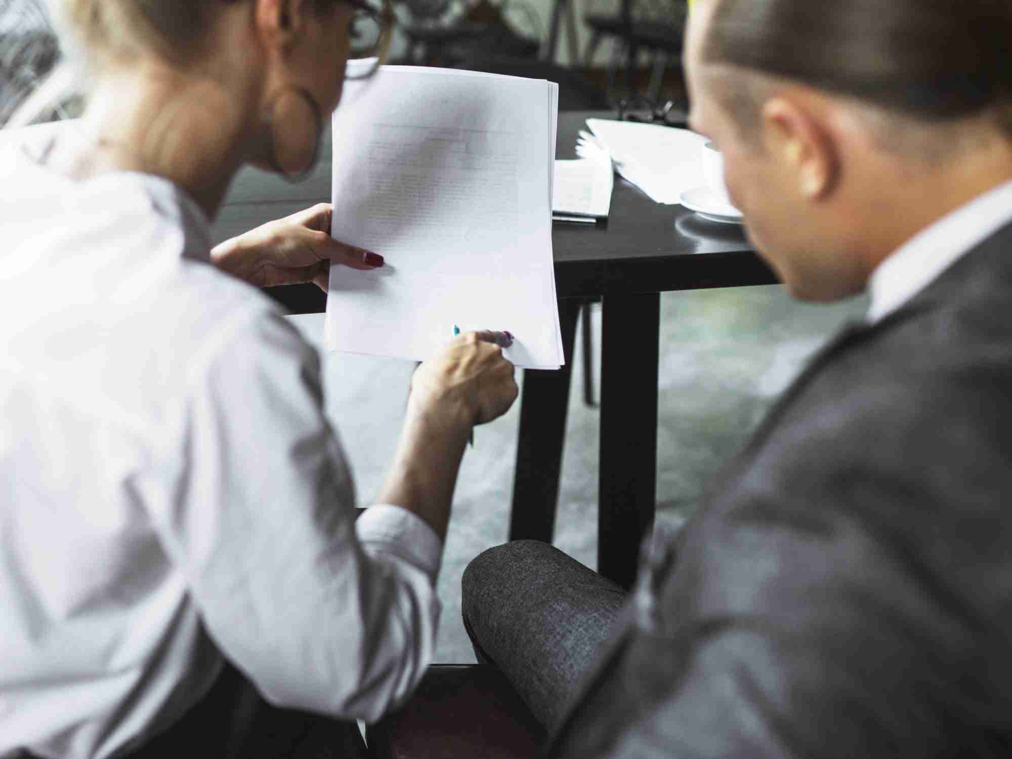 What are articles of incorporation? rear view two businesspeople examining document caf edited scaled